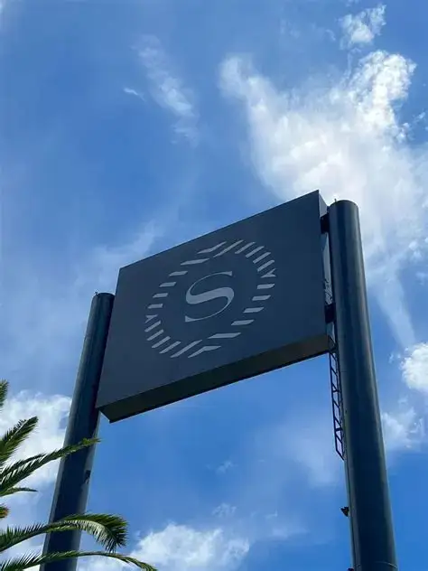 Entrada corporativa con revestimiento grafito y letras de acrílico